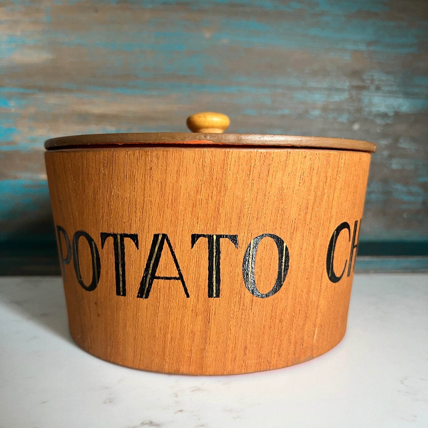 Wooden potato container with 'POTATO CHIP' text on a textured background