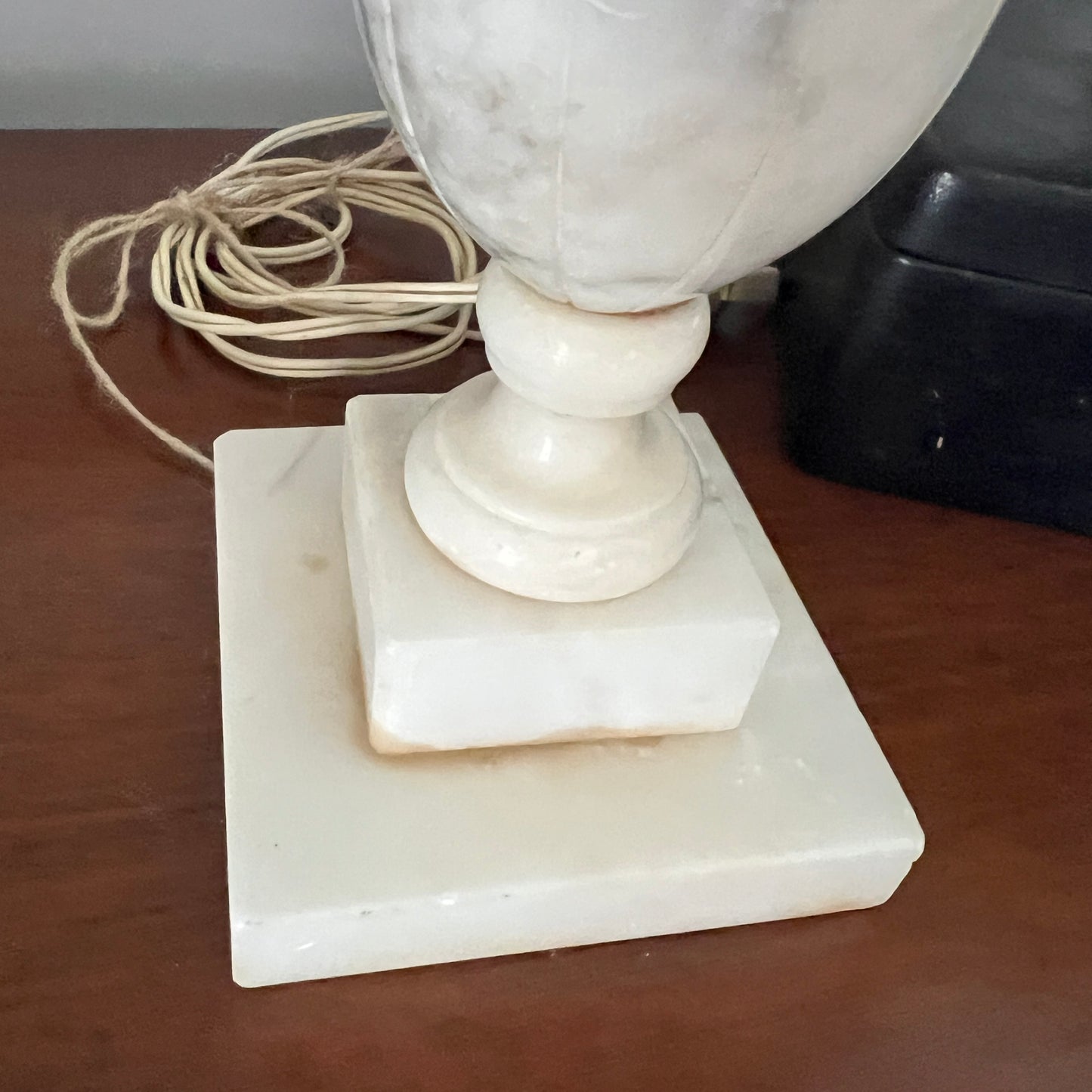 Marble lamp with square base on a wooden surface