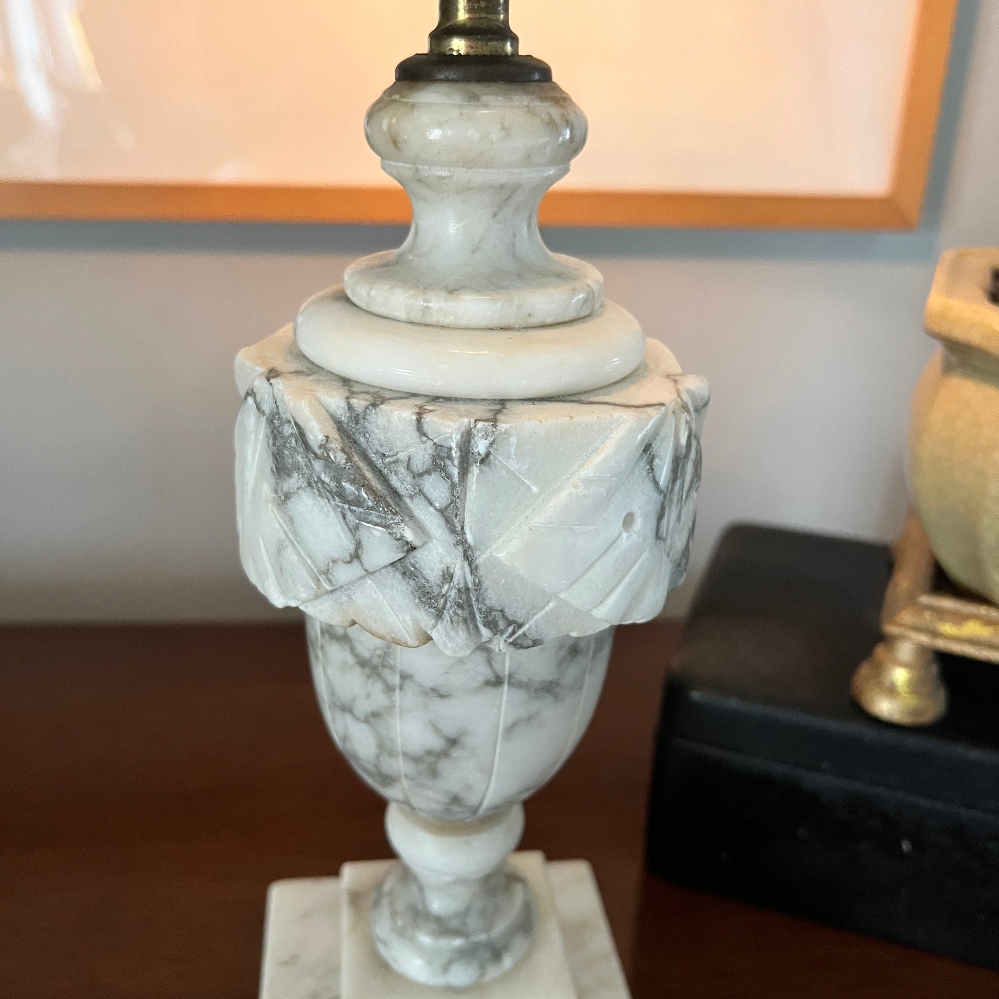 Marble-patterned lamp on a wooden surface with a blurred background