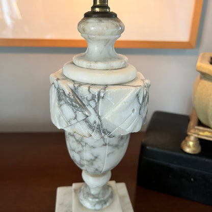 Marble-patterned lamp on a wooden surface with a blurred background
