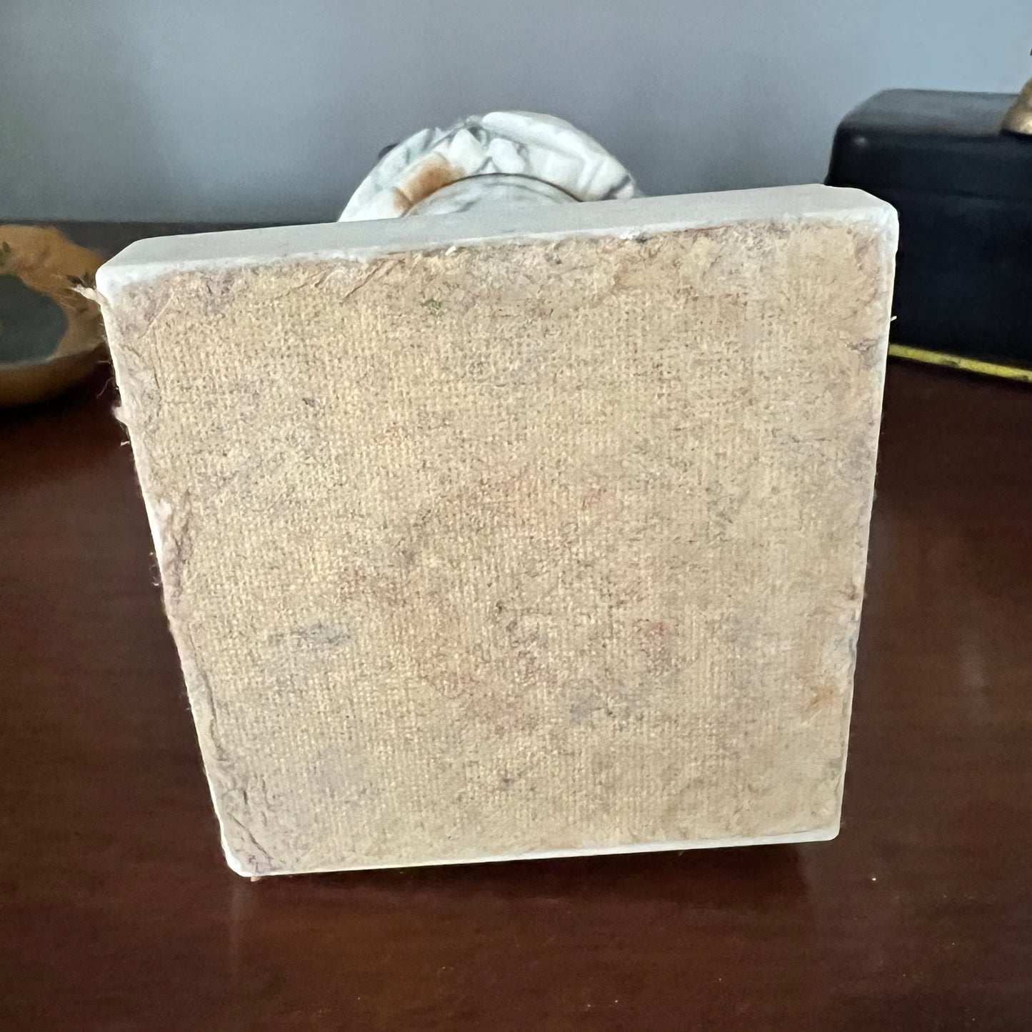 Square stone base on a wooden surface with a neutral background
