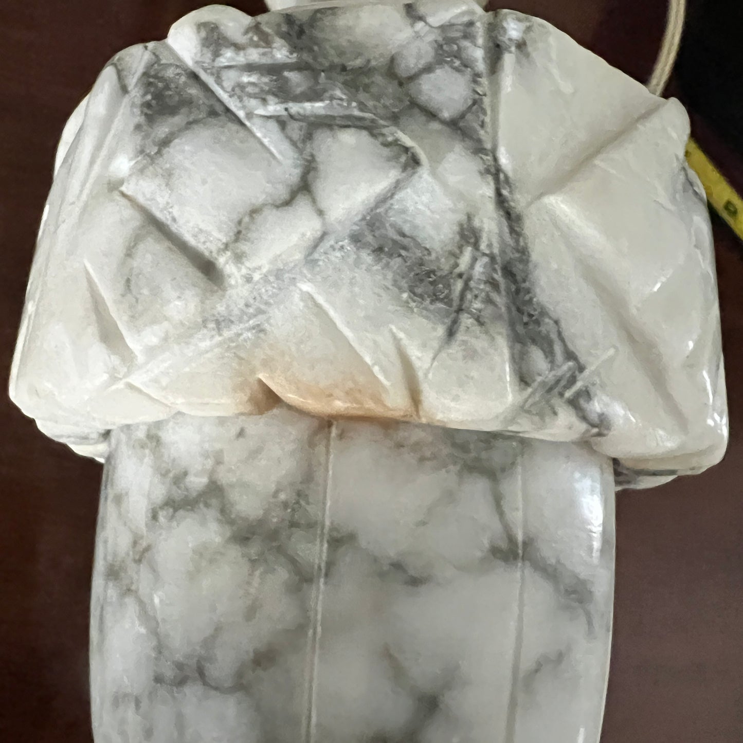Marble sculpture on a brown surface