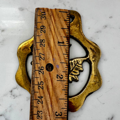 Wooden ruler with gold leaf design on a marble surface