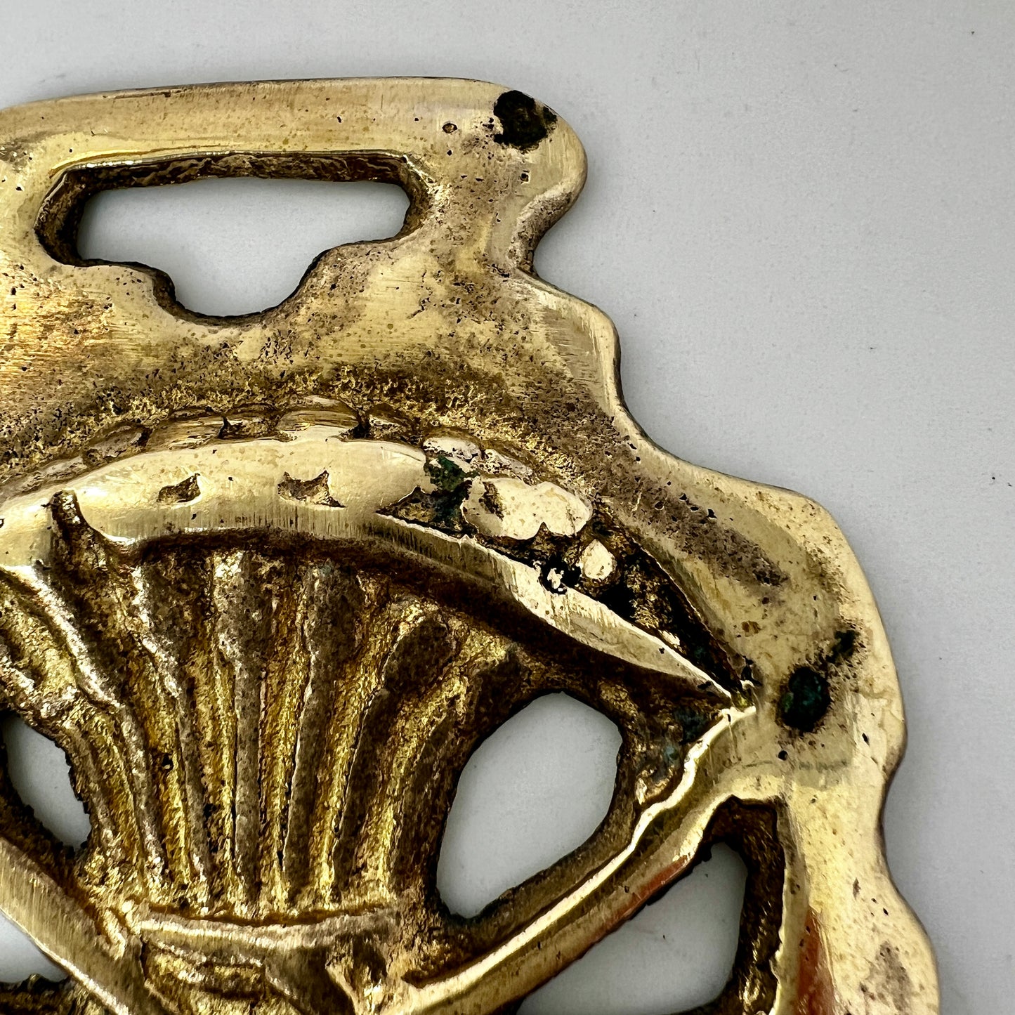 Brass pendant with design on a white background