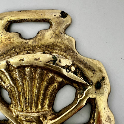 Brass pendant with design on a white background