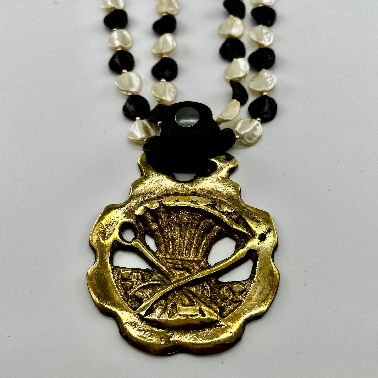 Necklace with gold pendant on a white background
