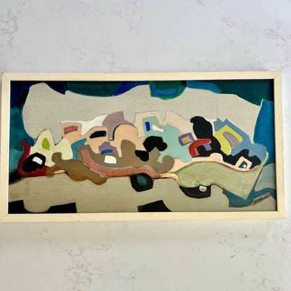 An abstract framed painting featuring organic shapes and blocks of teal, beige, brown, black, red, and light blue, mounted on a light-colored wall.