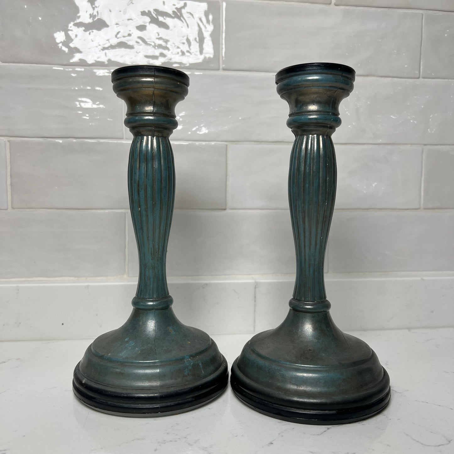 blue candle holders on a tiled background
