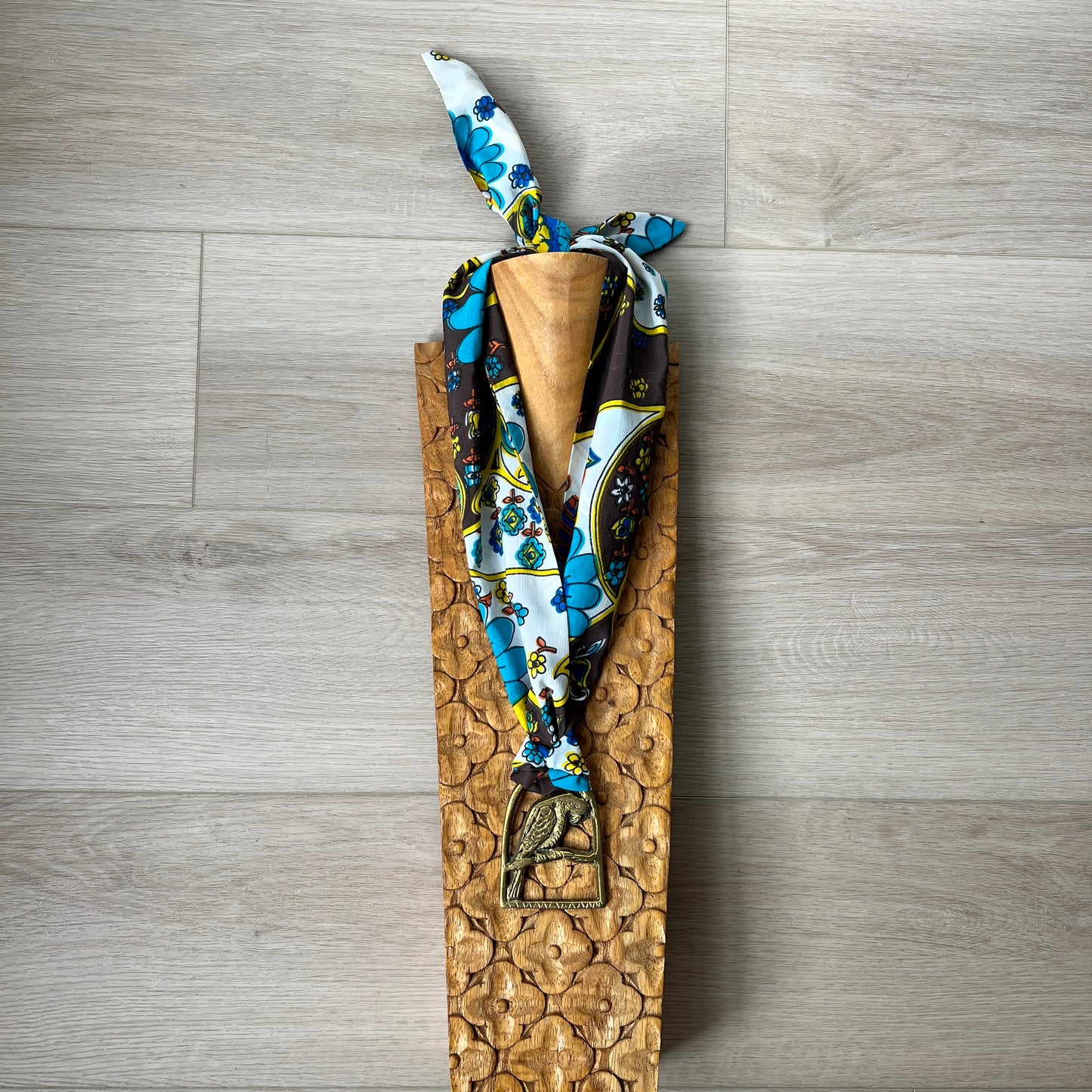 a patterned scarf on a wooden surface