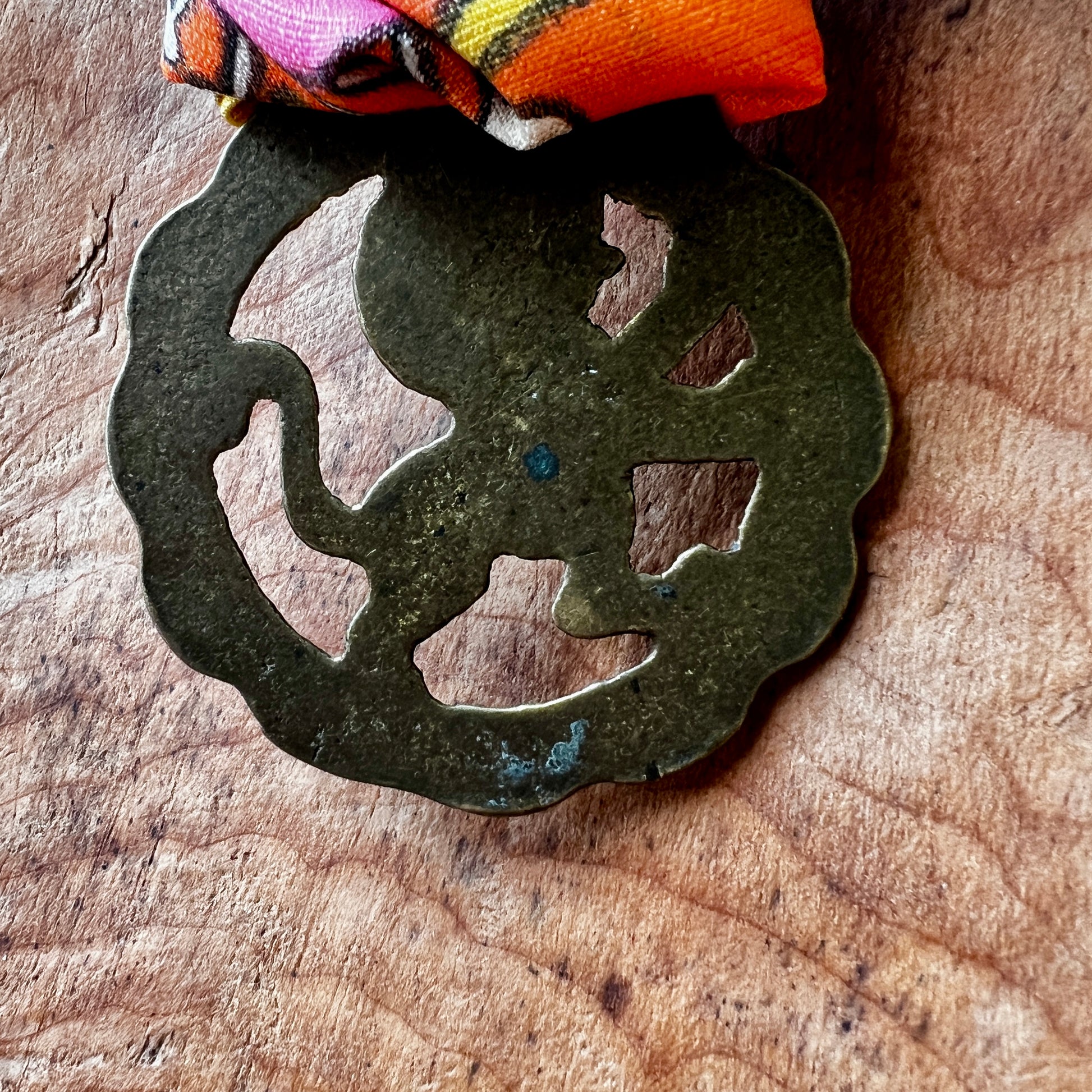 Bronze decorative element on a wooden surface