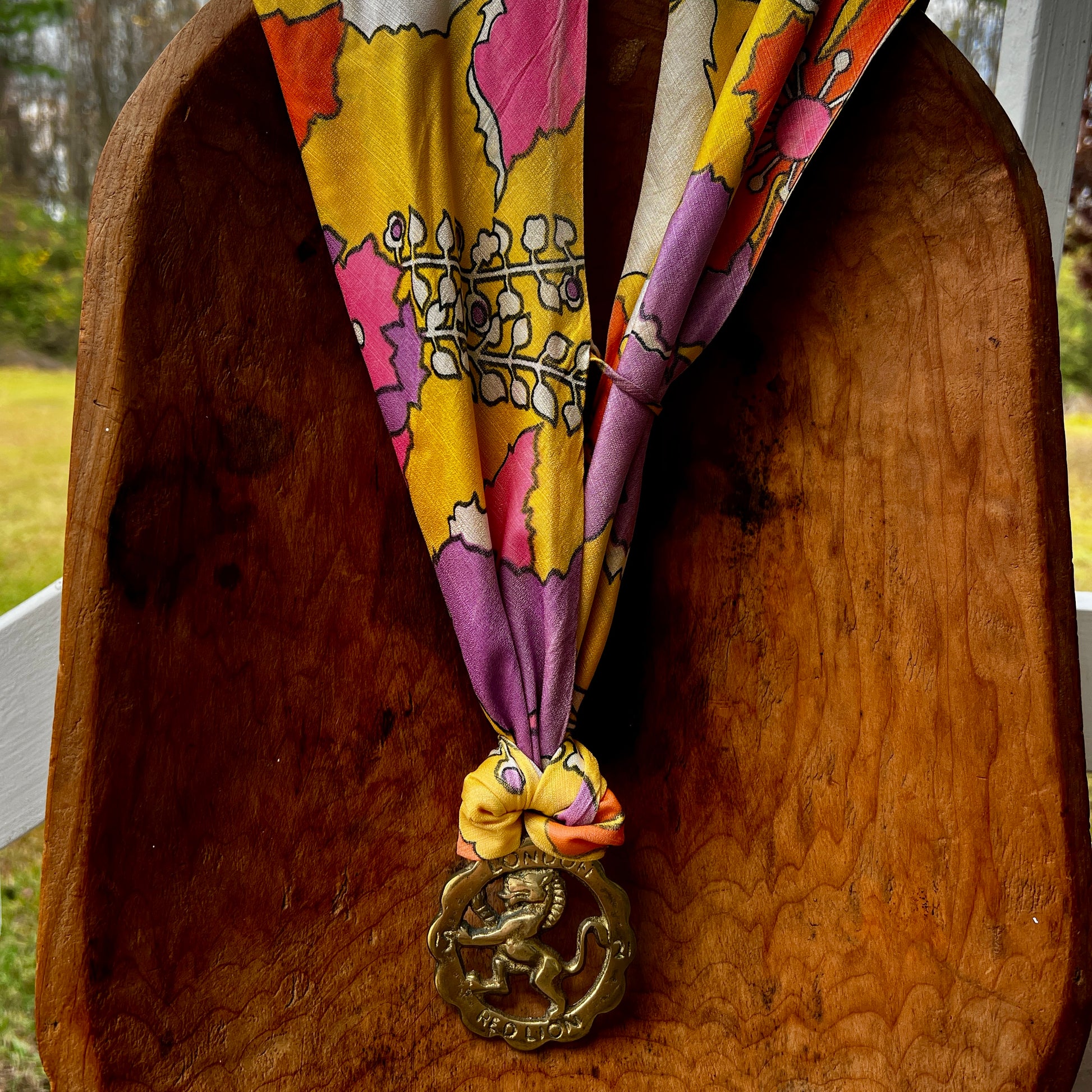 Colorful lanyard with a decorative charm on a wooden surface