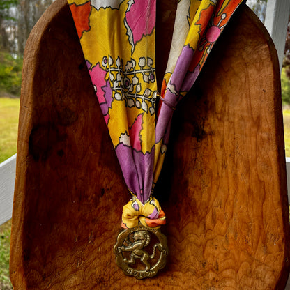 Colorful lanyard with a decorative charm on a wooden surface