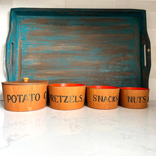 4 piece teak snack bowl set with bold orange interior blue tray on white marble