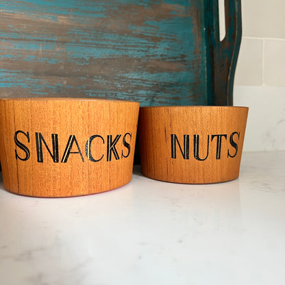 teak snack bowl set with bold orange interior blue tray on white marble says snacks on one and nuts on the other