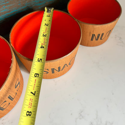 Three wooden containers with orange interiors, labeled 'SNACKS' and 'NUTS', with a measuring tape for scale on a light background.