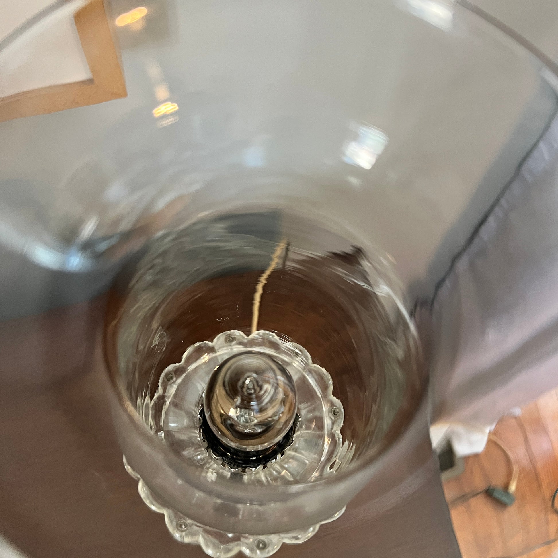 Close-up of a clear glass vase with a decorative base.