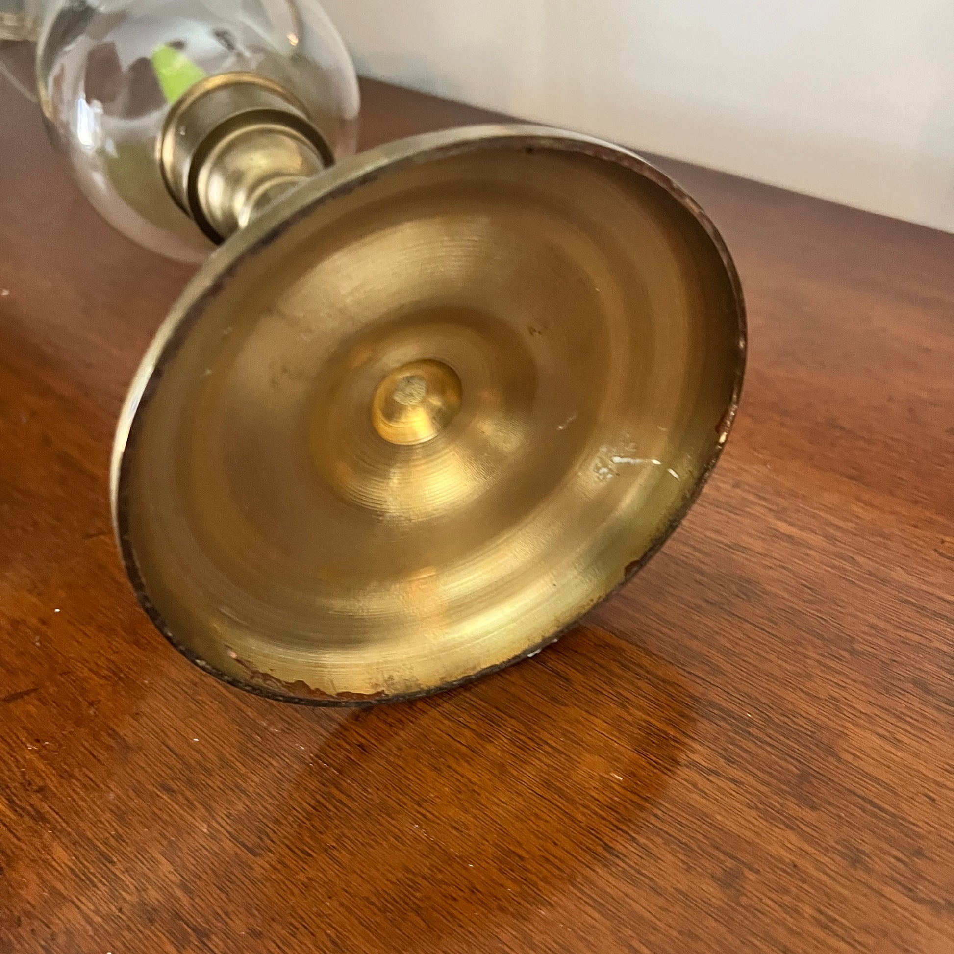 Close-up of a brass candlestick holder on a wooden surface