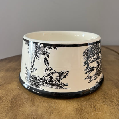 Ceramic bowl with black and white dog design on a wooden surface
