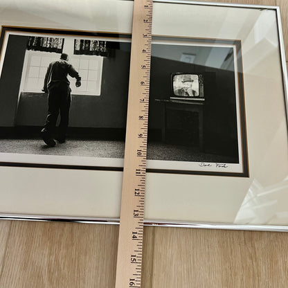 Framed black-and-white photograph , with a wooden ruler placed vertically between them for scale. Photo shows a monochrome photo of a person standing in a room near a window, and  a vintage television set.