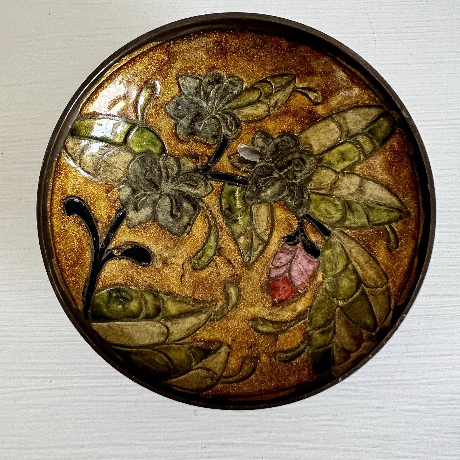 Decorative bowl with floral design on a textured surface