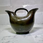 modern-double-spout-metal-vase on a marble countertop with a tiled wall background