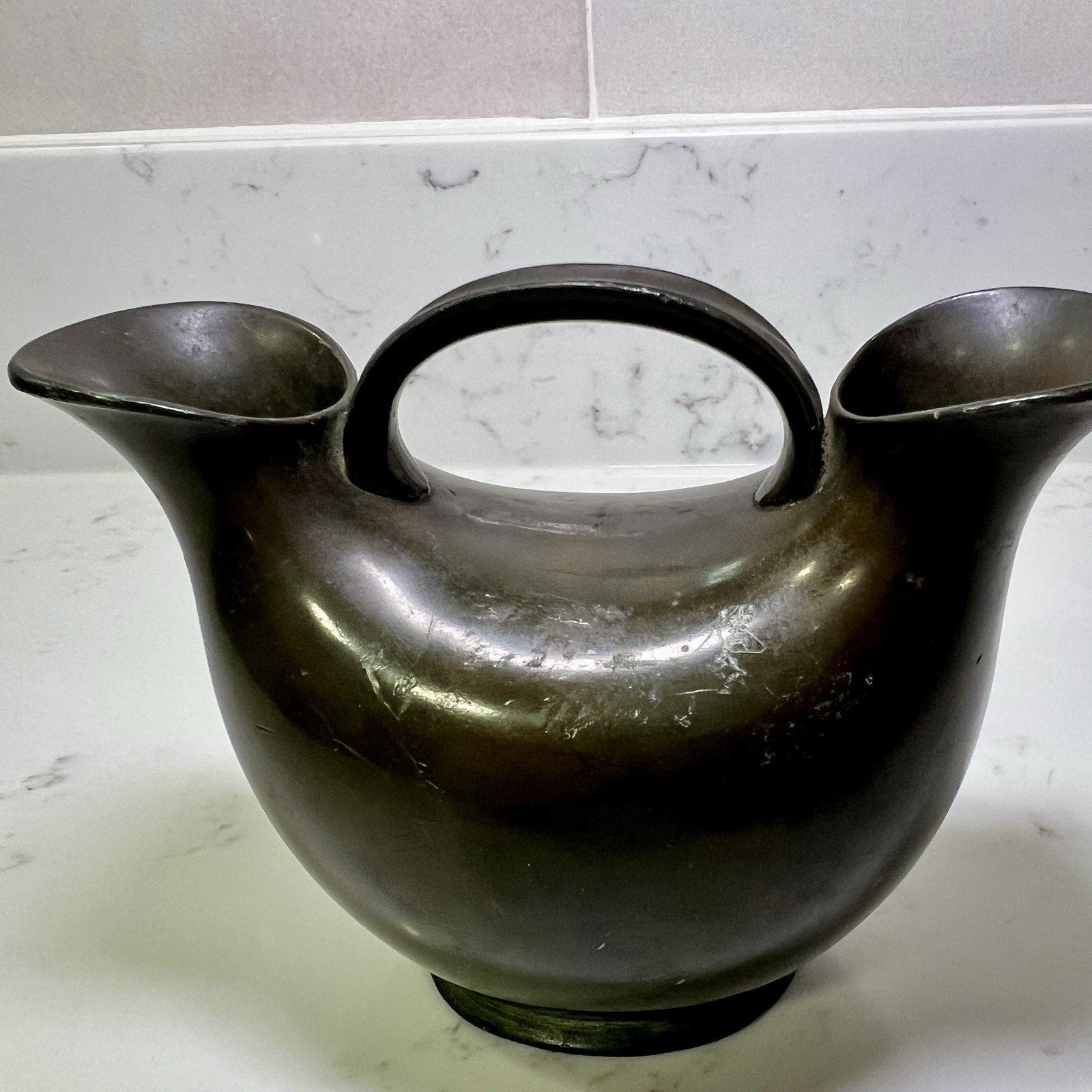 double spout vase on a marble surface