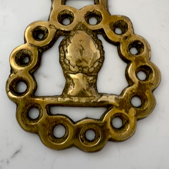 Video of Vintage horse brass medallion necklace with geometric scarf, rustic equestrian jewelry on white background.