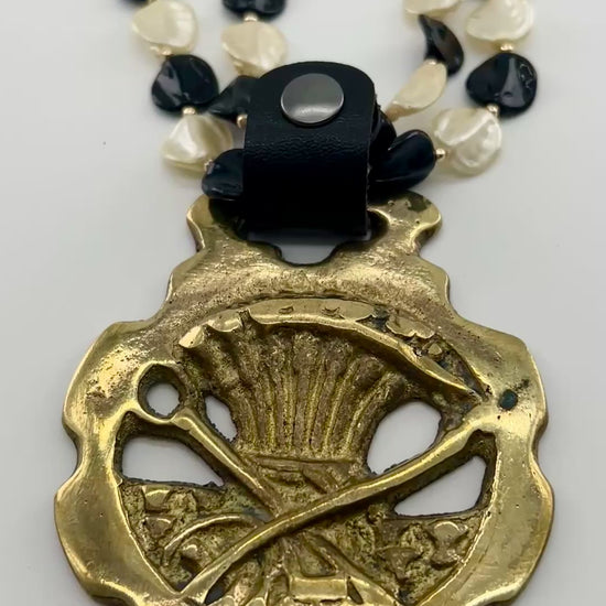 Video of Brass Scythe & Wheat Horse Medallion Necklace on white background