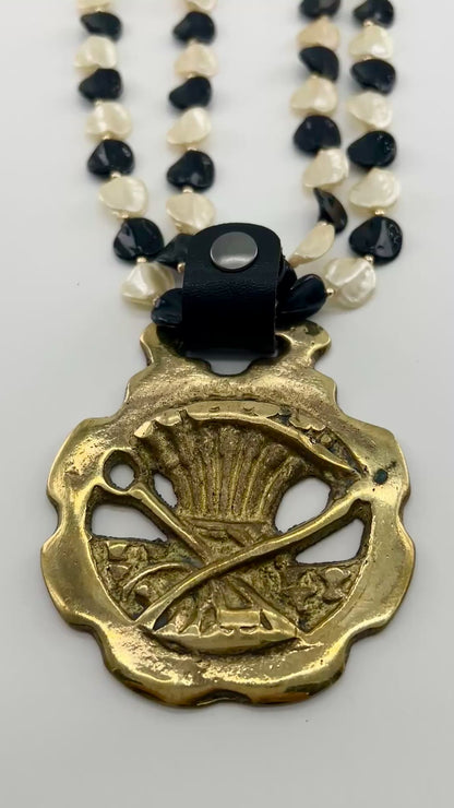 Video of Brass Scythe & Wheat Horse Medallion Necklace on white background