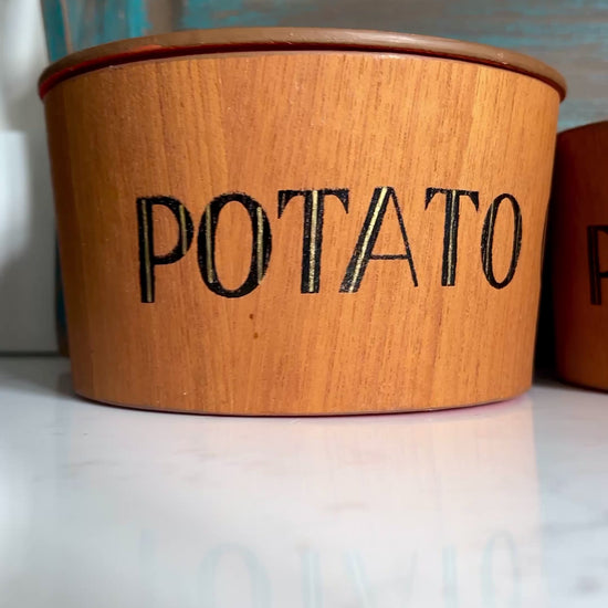 Video of teak snack bowl set with bold orange interior blue tray on white marble