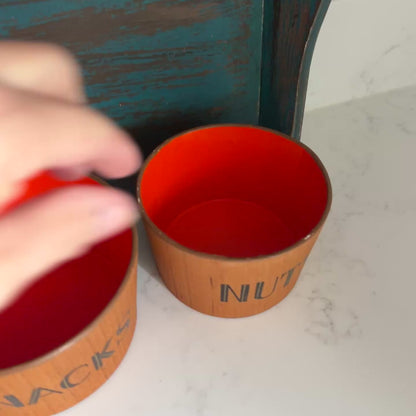 Video of teak snack bowl set with bold orange interior blue tray on white marble