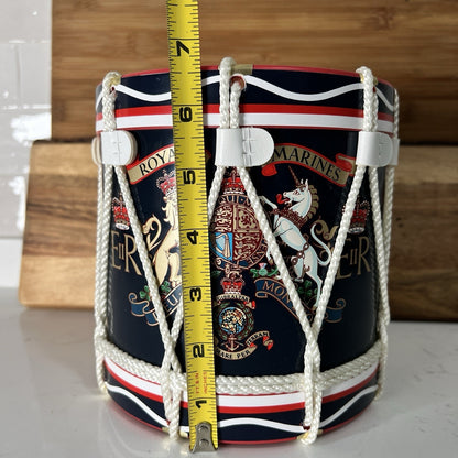 Decorative drum ice bucket 
with embroidered designs and a measuring tape for scale on a wooden background