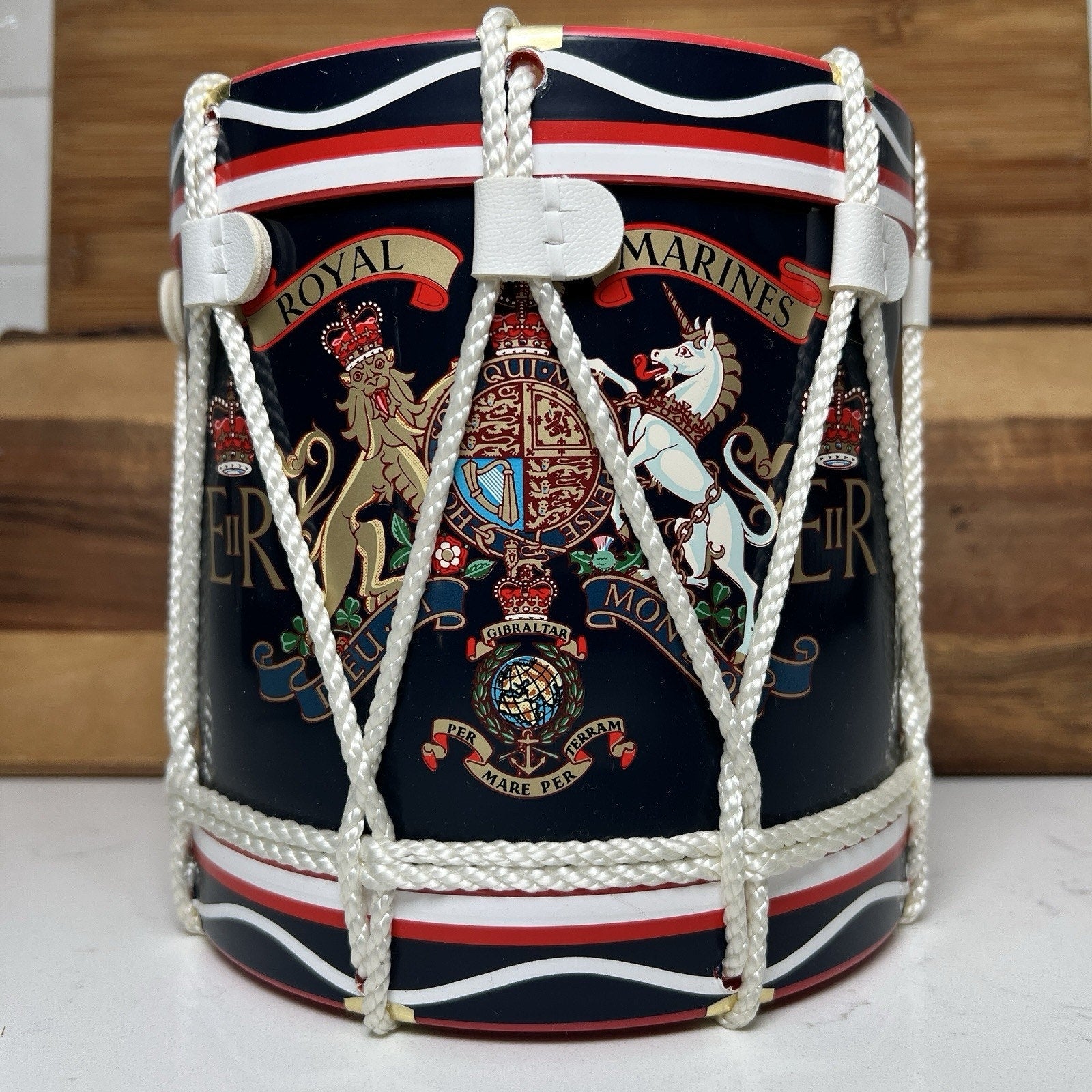 Decorative drum with Royal Marines insignia on a wooden background