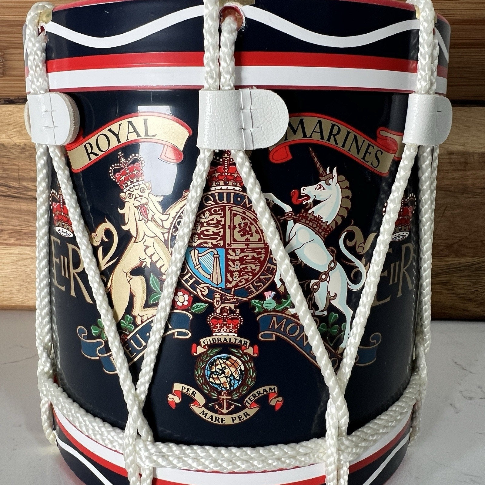 Decorative drum with Royal Marines insignia on a wooden background